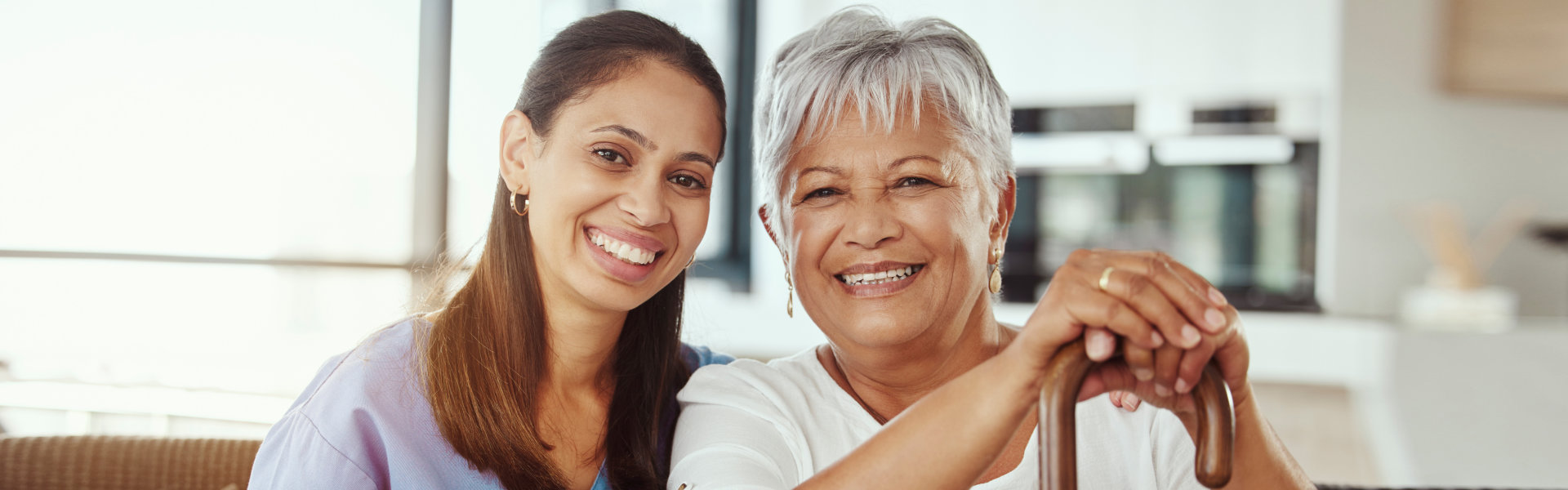 Caregiver and elderly smiling